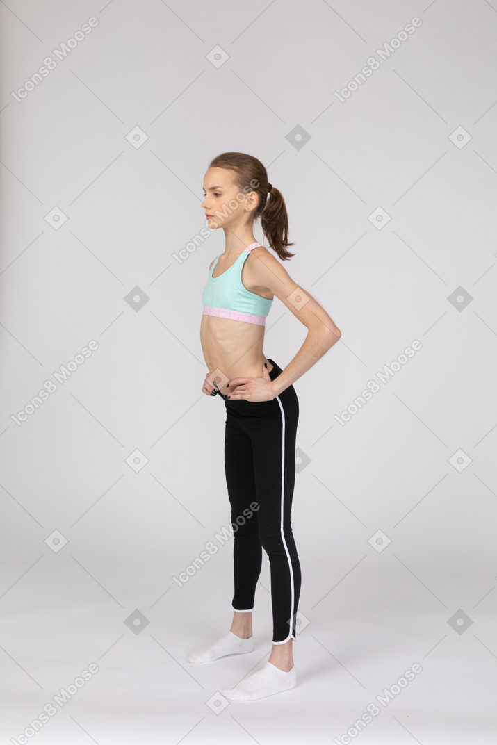 woman in black sports bra lean forward one hand Stock Photo