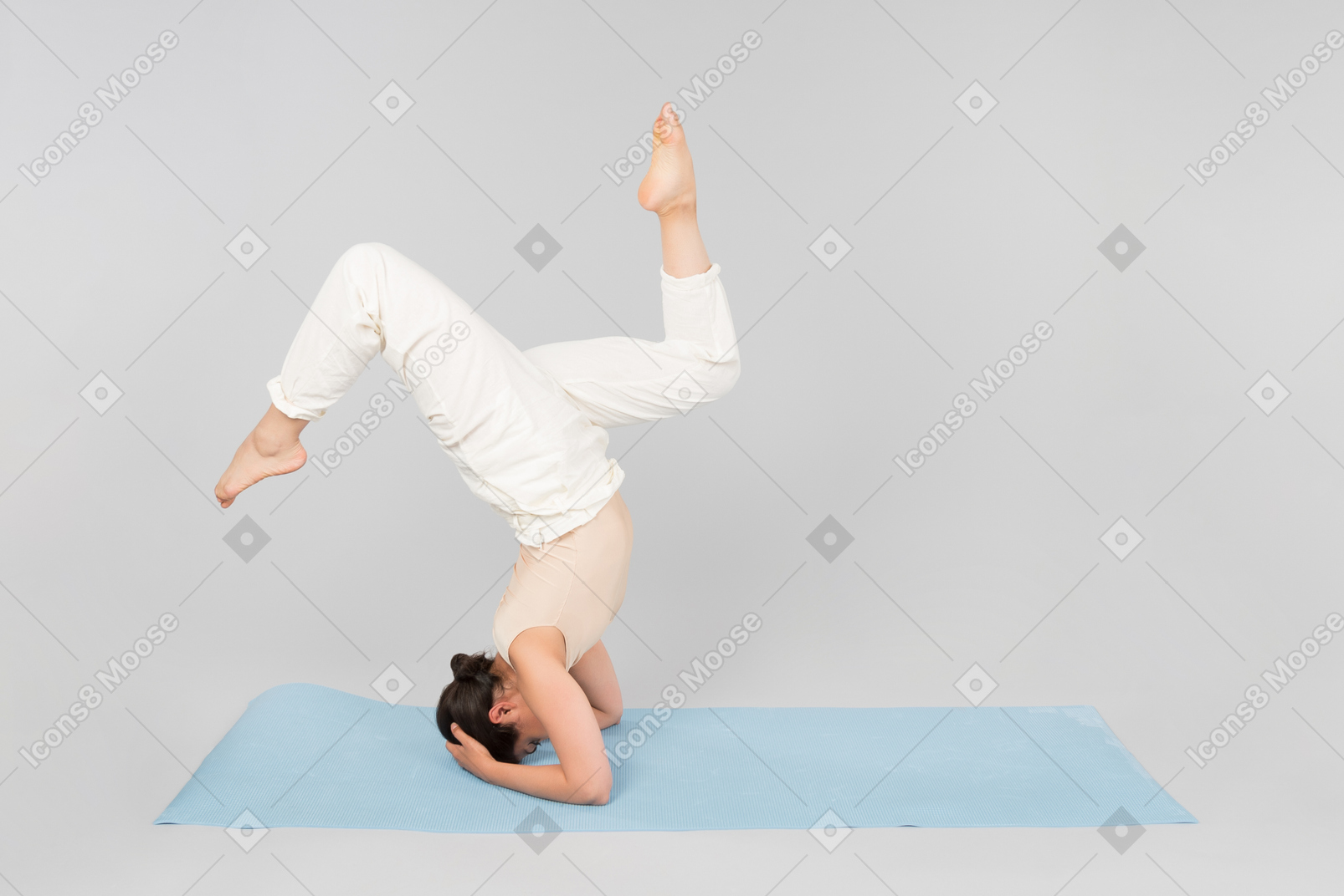 Young indian woman standing on the head on yoga mat