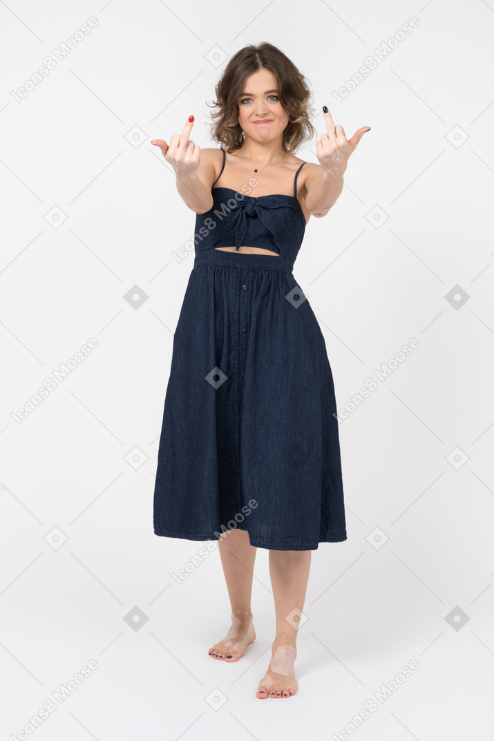 Displeased brunette woman showing a middle finger