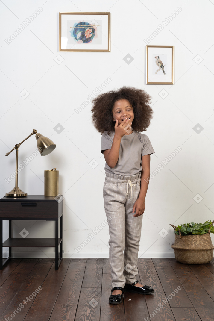 Good looking girl kid posing on the apartment background