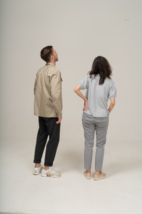 Back view of young man and woman looking away
