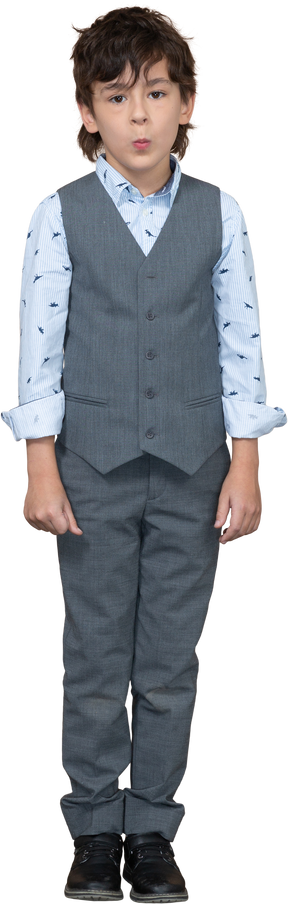 Front view of a cute boy in suit looking at camera