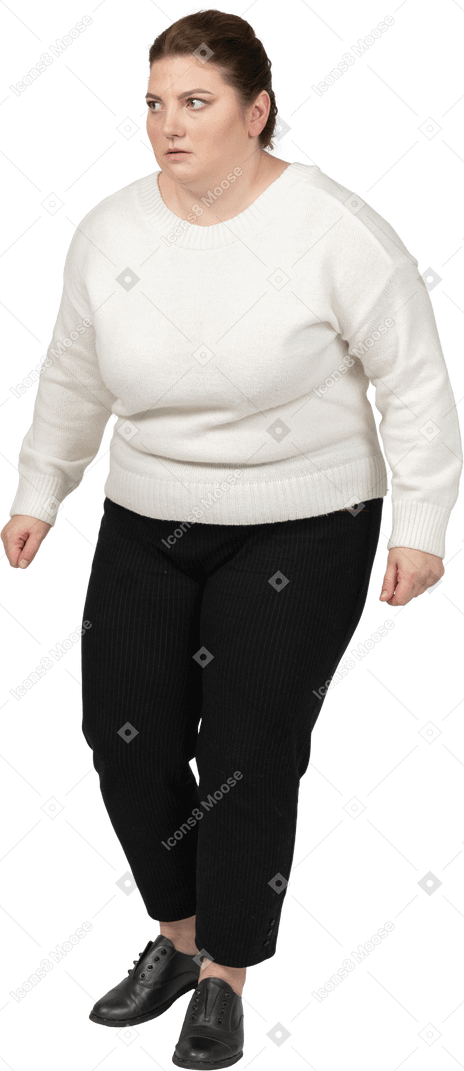 Scared plump woman in casual clothes standing