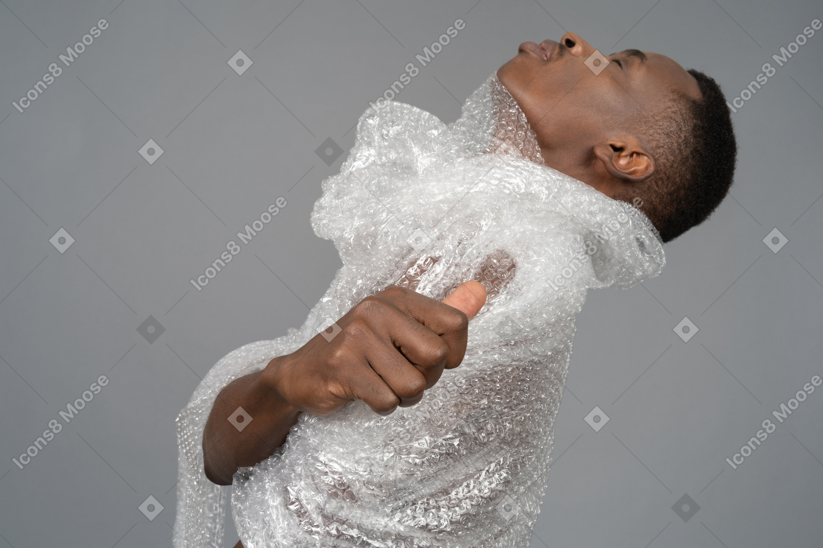Side view of an african man trying to take off plastic wrap