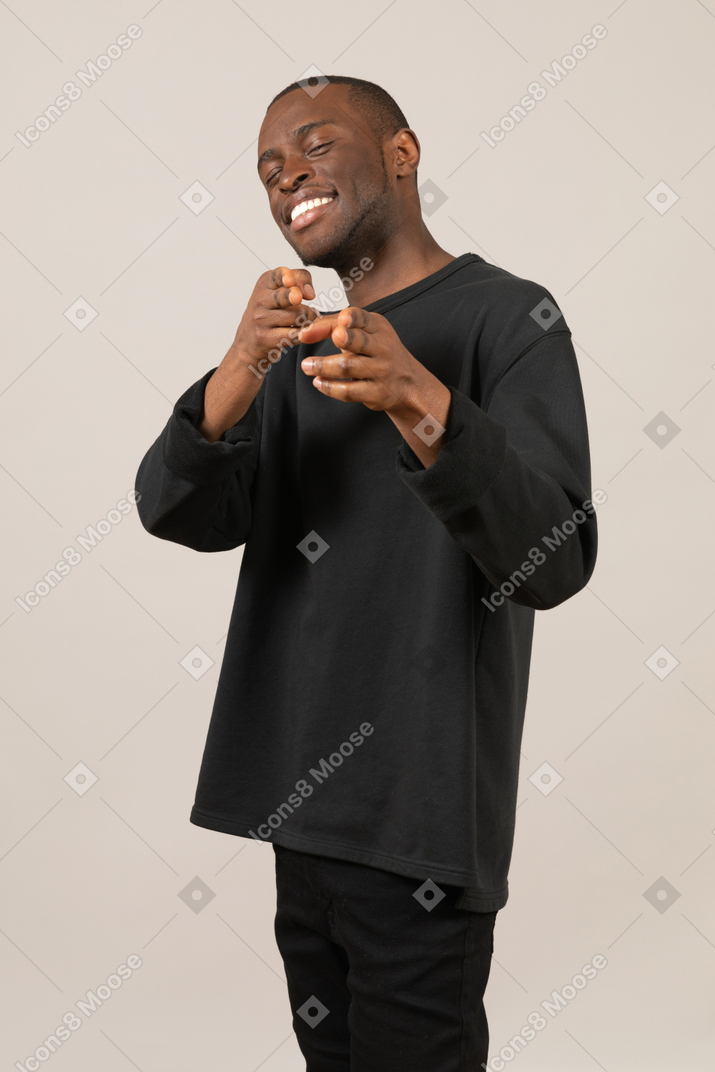 Smiling man pointing at camera
