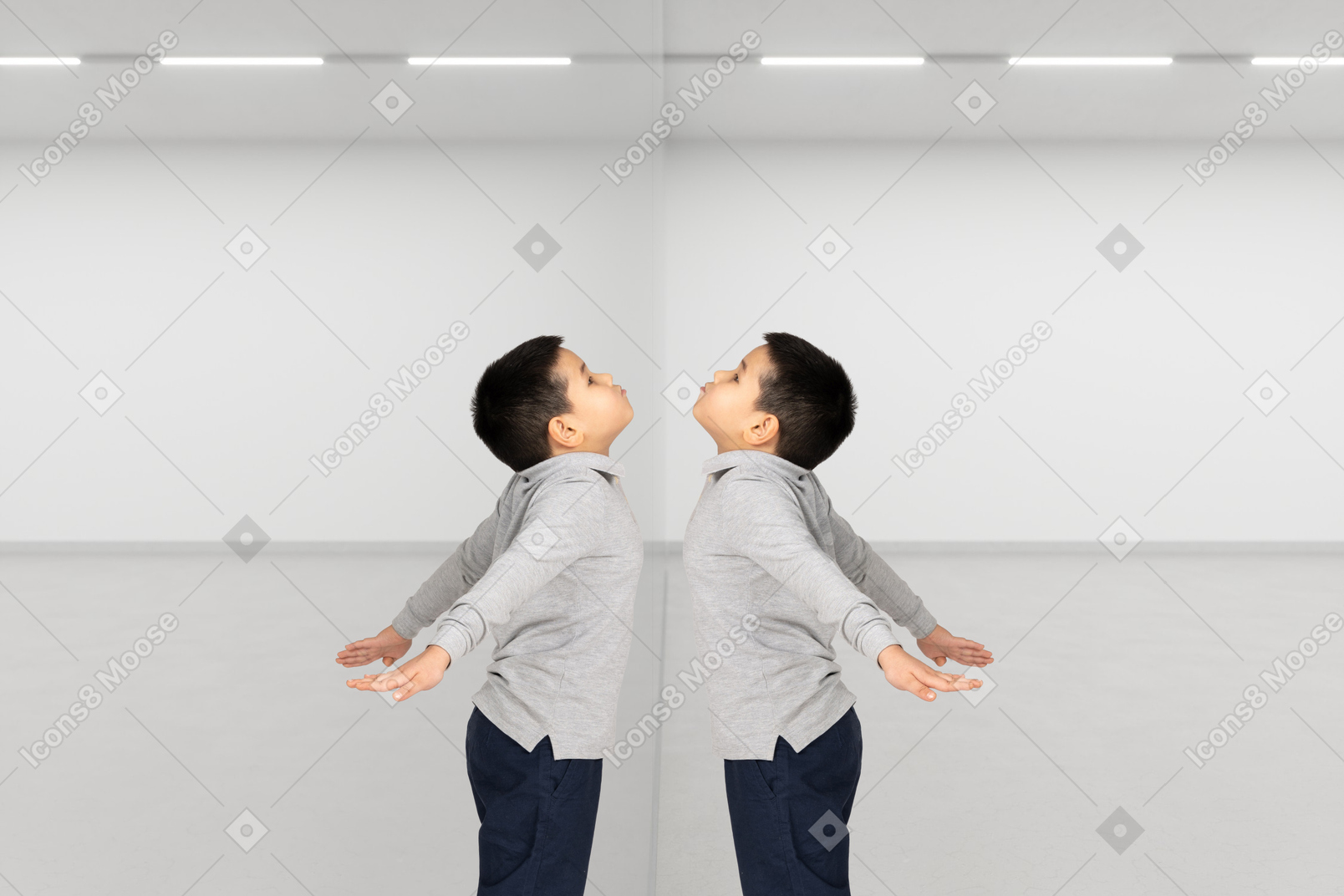 Little boy standing at the mirror