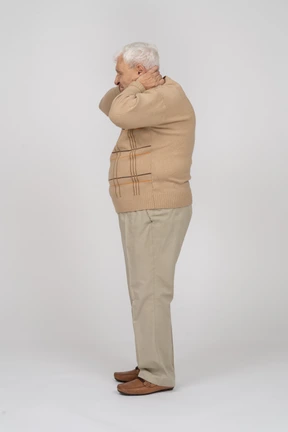 Side view of an old man suffering from neck pain