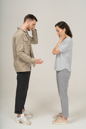 Side view of young couple speaking to each other