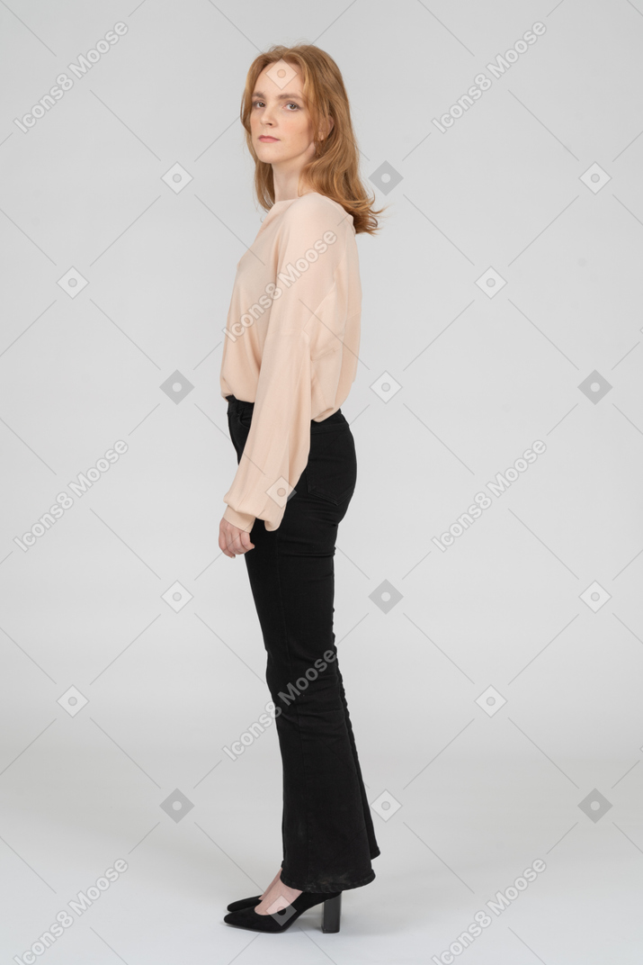 Side view of redhead woman looking ar camera