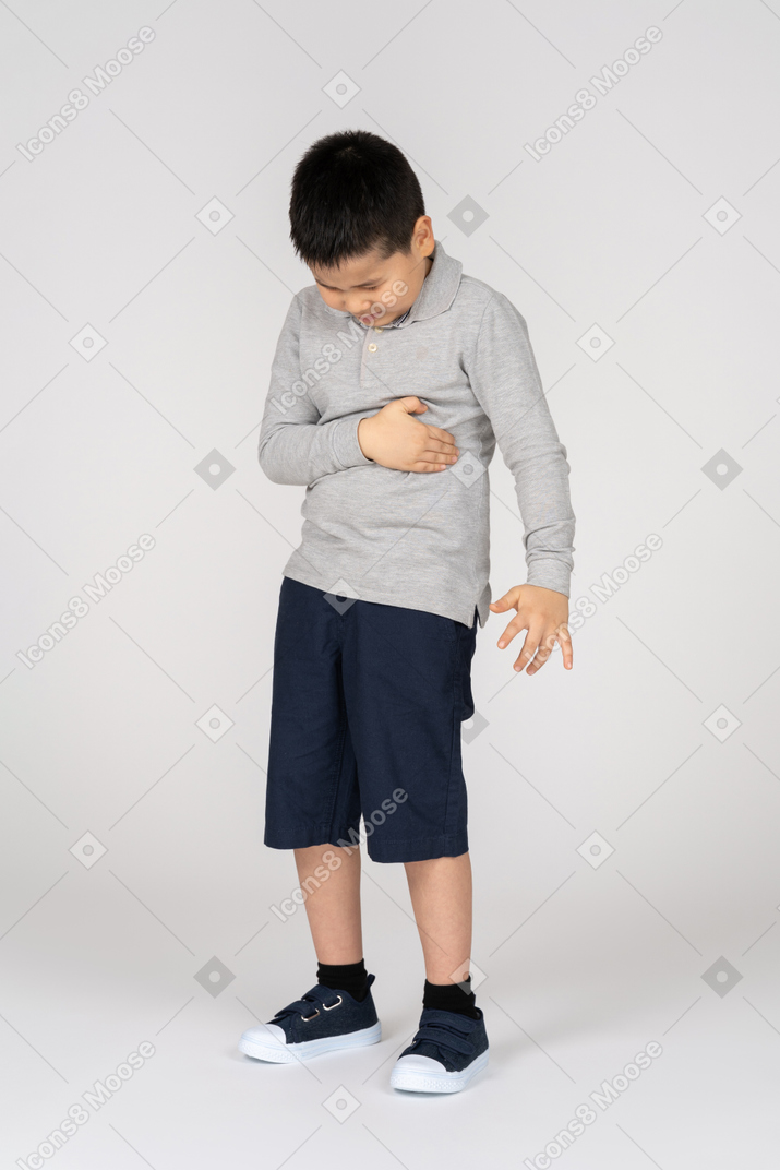 Boy in pain holding stomach