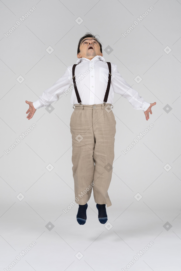 Middle-aged man levitating with spread arms