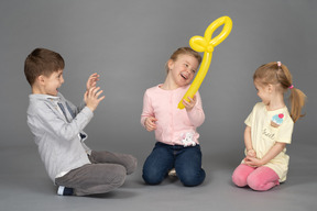 Happy children playing with balloon