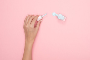 Bottle lying sideways spilling out nail varnish