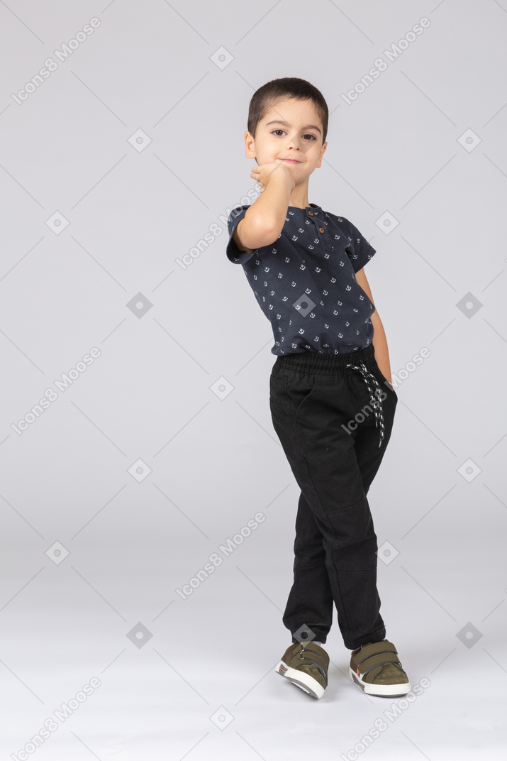 Front view of a cute boy posing with with hand in pocket