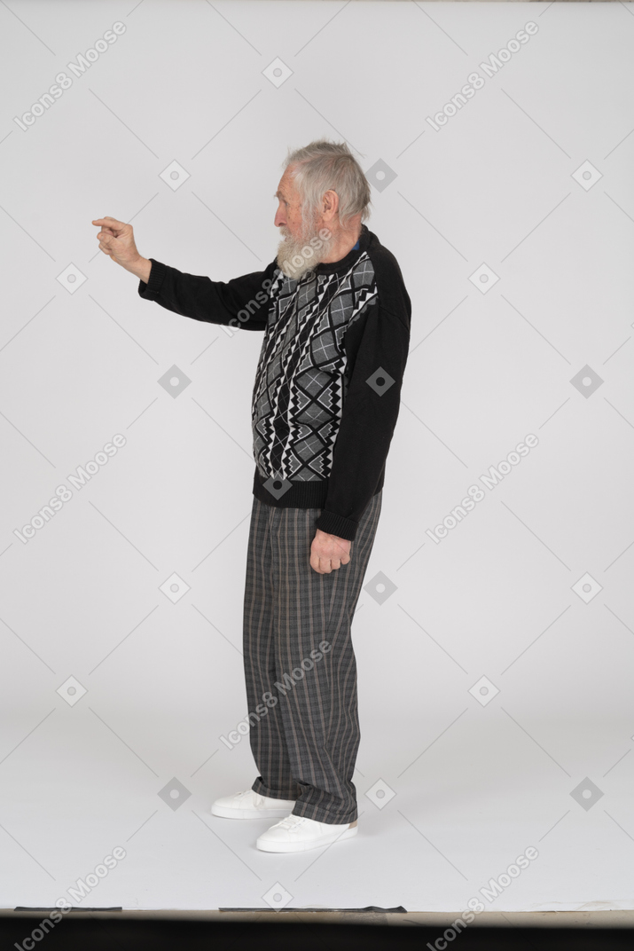 Side view of old man showing little gesture with fingers
