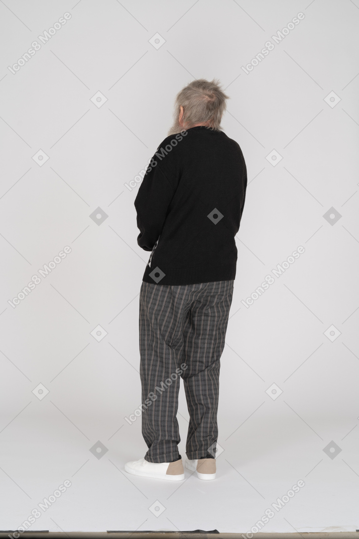 Old man standing with his back toward the camera