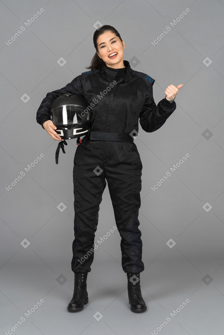 A smiling female biker posing with a helmet
