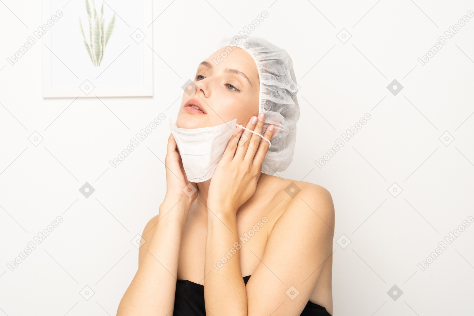 Young woman putting on mask
