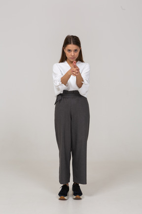 Front view of a young lady in office clothing making a shot