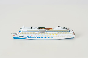 The toy cruise ship on the light grey background