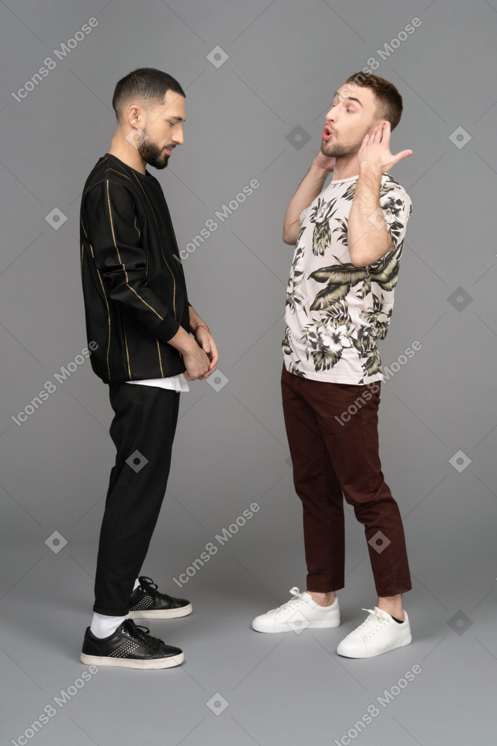 Young angered man telling another young man off