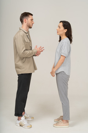 Side view of young couple speaking to each other