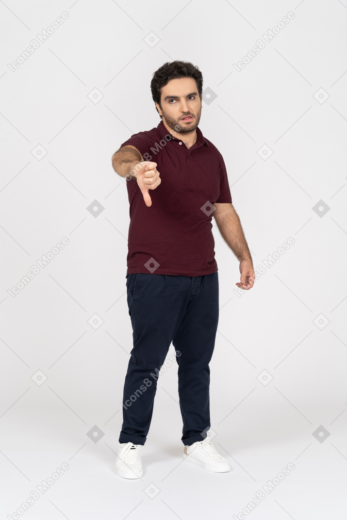 Disgruntled man pointing his thumb down