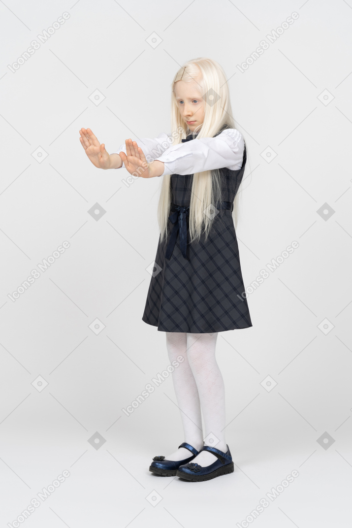Schoolgirl putting hands in front of her body