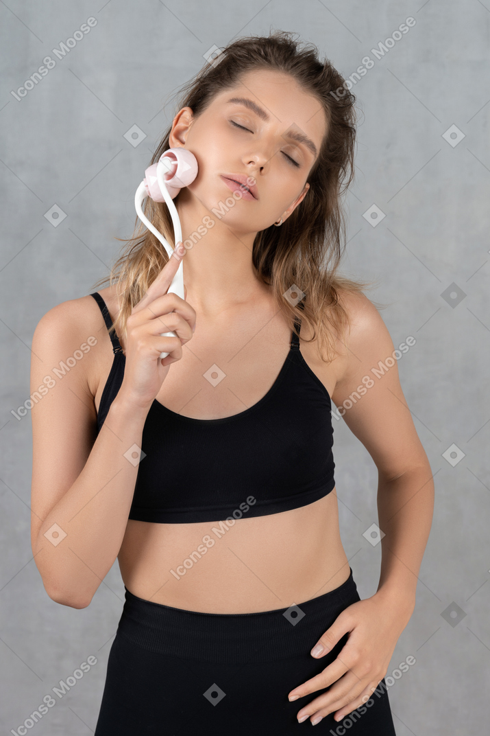 Portrait of an attractive young woman feeling relaxed while massaging her face
