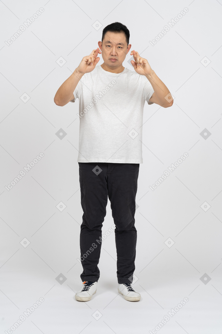 Front view of a man with crossed fingers