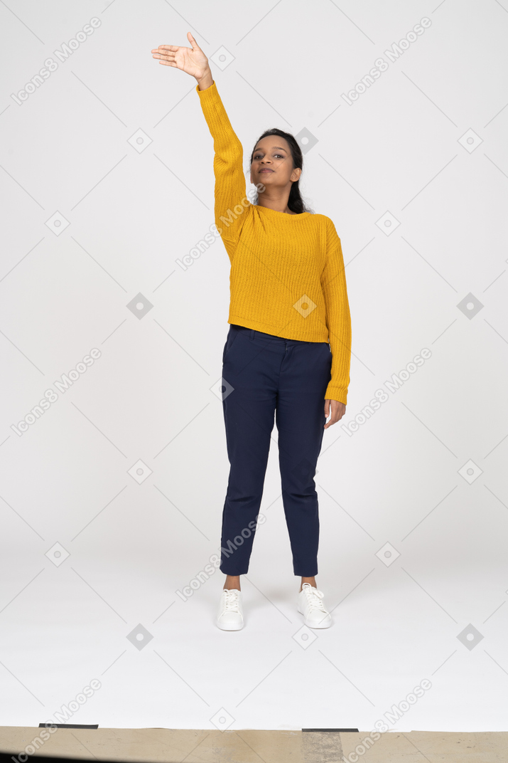 Front view of a girl in casual clothes waving
