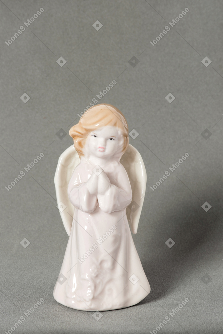 Mini angel statue on grey background