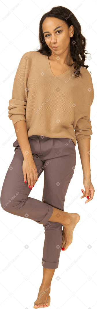 Full-length of a dark-skinned female in casual clothes grimacing