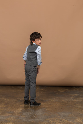 Rear view of a boy in grey suit