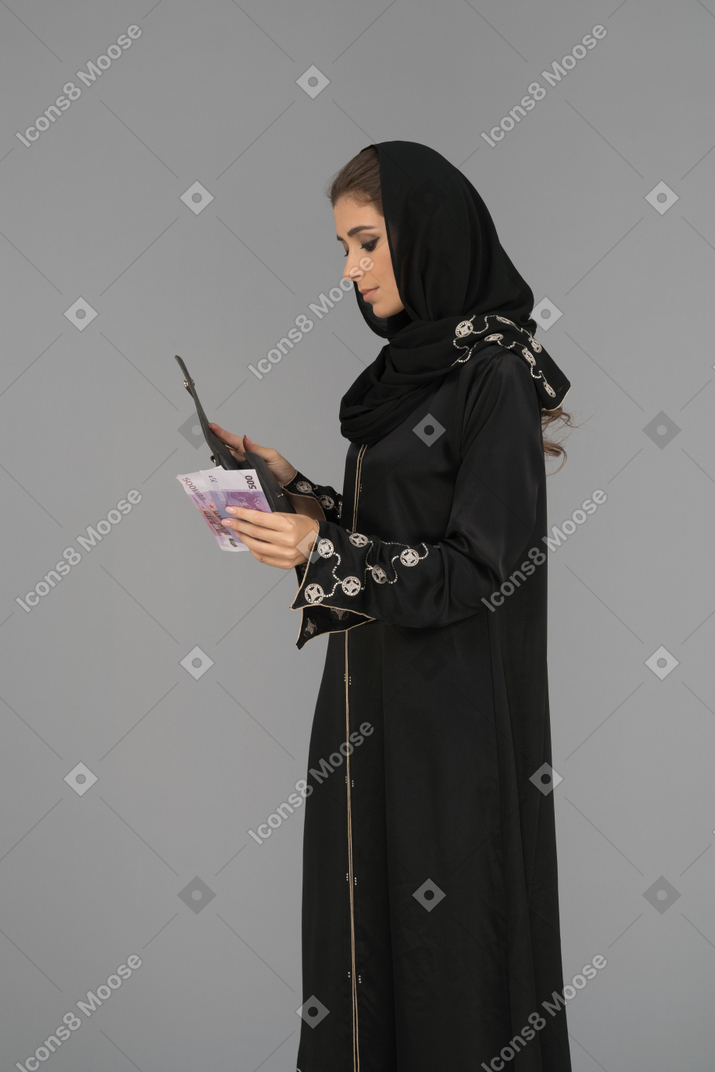 Young muslim woman holding banknotes