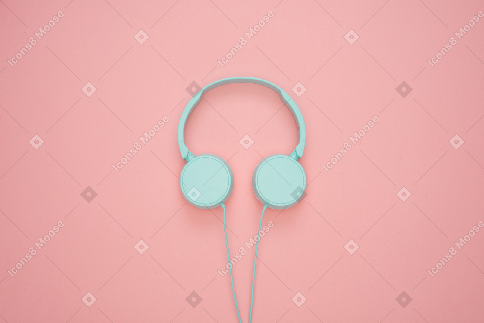 Blue headphones over pink pastel background