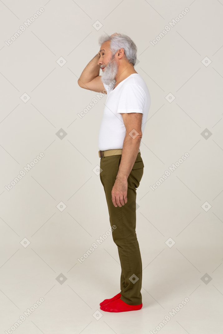 Side view of a man scratching his head
