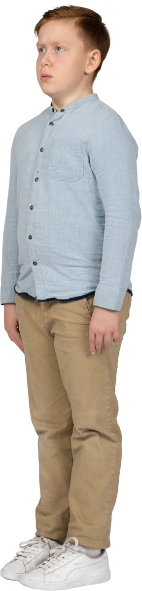 Sad boy in casual clothes standing still