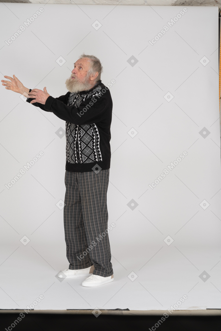 Old man raising arms and looking up