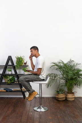 Good looking young man sitting on a chair