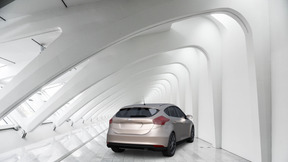 A silver car is parked in a tunnel