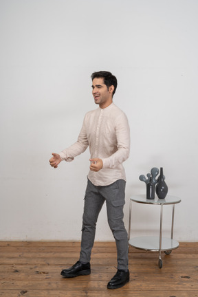 Side view of a man in casual clothes gesturing