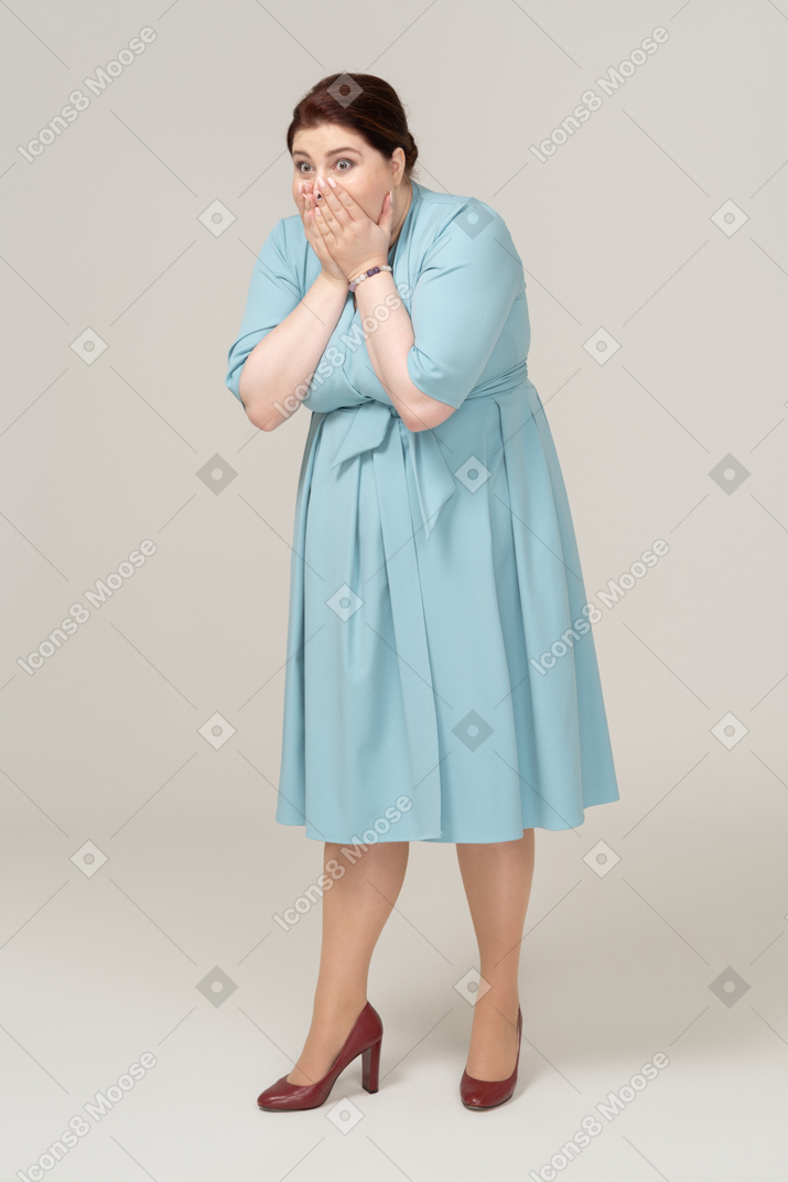 一个穿着蓝色裙子的震惊女人的前视图