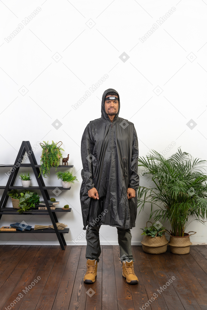 Mürrischer mann im regenmantel mit geballten fäusten