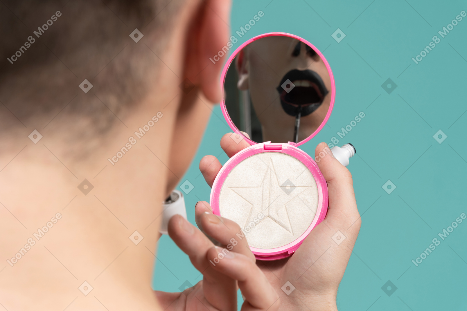 Back view of a person holding mirror and putting on lipstick