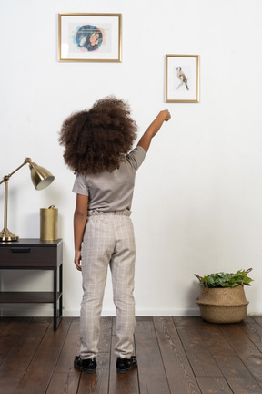 Good looking girl kid posing on the apartment background