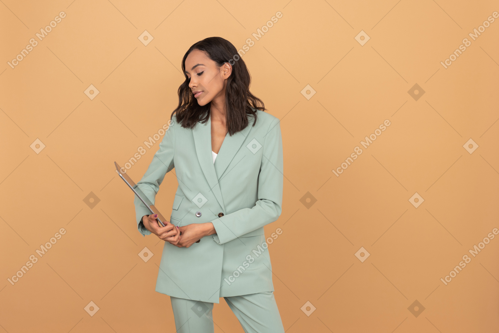 Attractive young office worker looking something at the tablet
