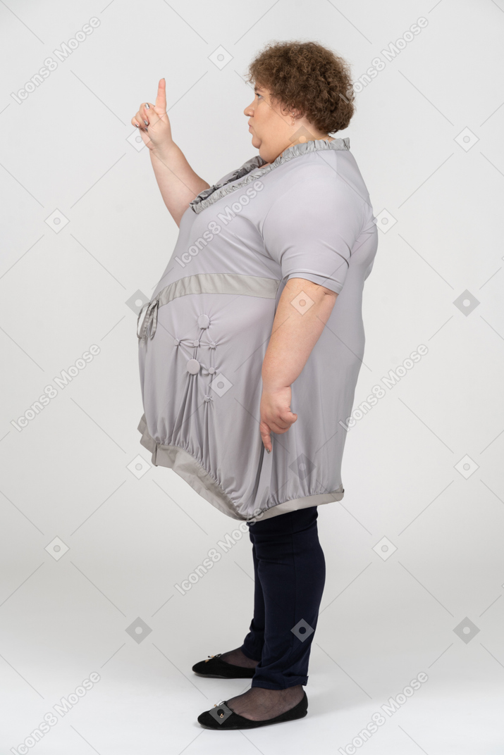 Side view of woman pointing up