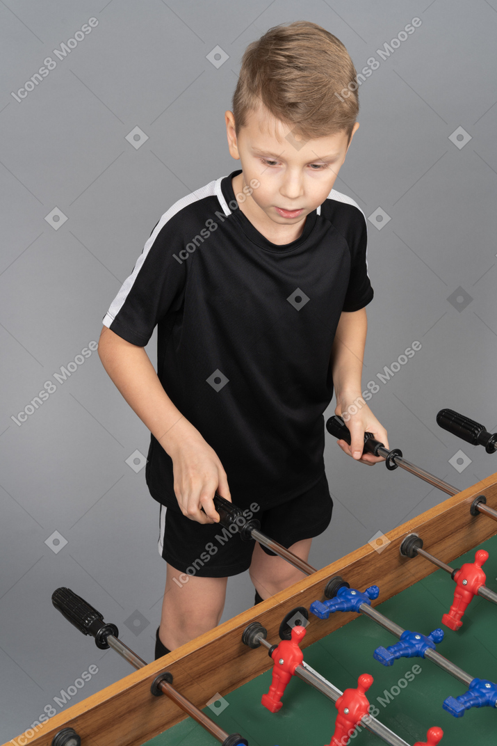 Close-up of a boy playing foosball