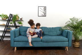 Cute boy and girl reading the book